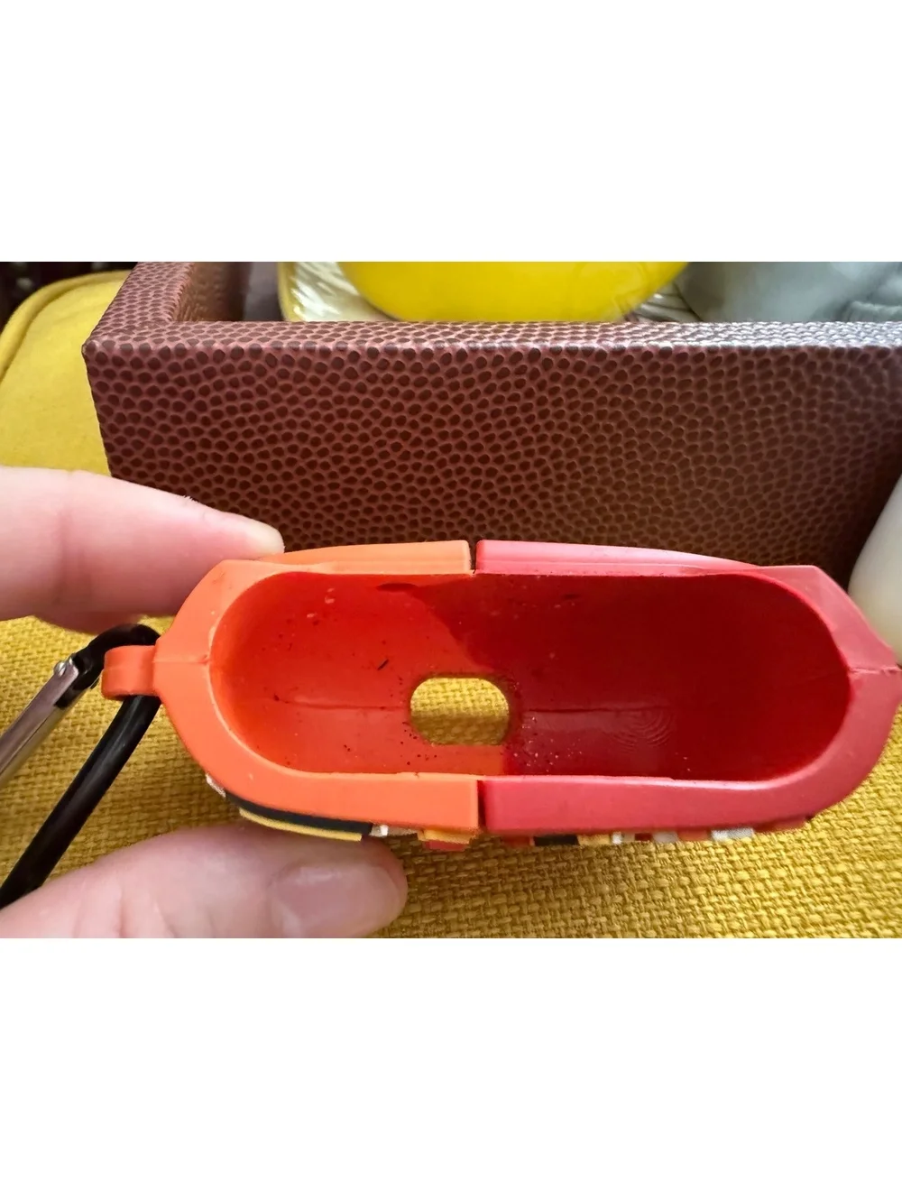 AirPods charger and half of a Cheetos case